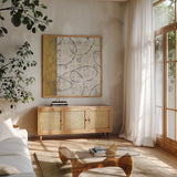 Earth Matter I Gold by Michael Mullan. Shown in a natural wood frame in a cozy modern living room. Available as an archival giclee rolled canvas, fine art paper, or poster print. SKU 30295a.