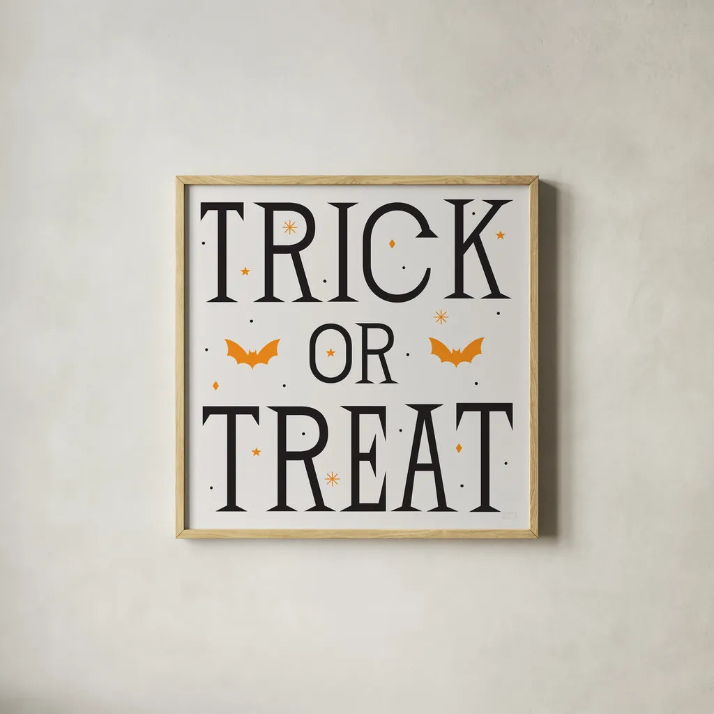 Festive Fright Trick or Treat II by Michael Mullan. Shown in a natural wood glass frame for a timeless modern aesthetic. Available as an archival giclee rolled canvas, fine art paper, or poster print. SKU 48269a.