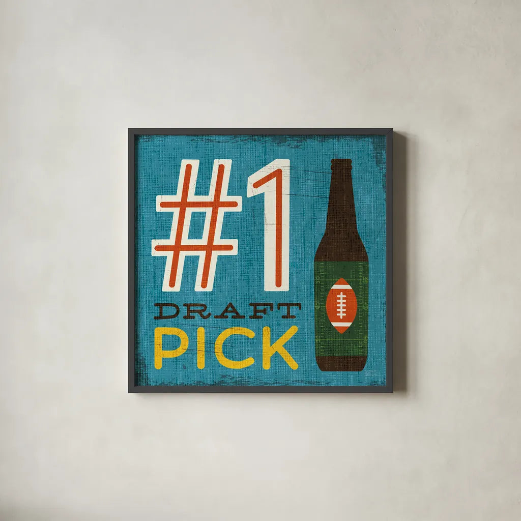 Football III by Michael Mullan. Shown in a sleek black glass frame for a contemporary gallery look. Available as an archival giclee rolled canvas, fine art paper, or poster print. SKU 17537a.