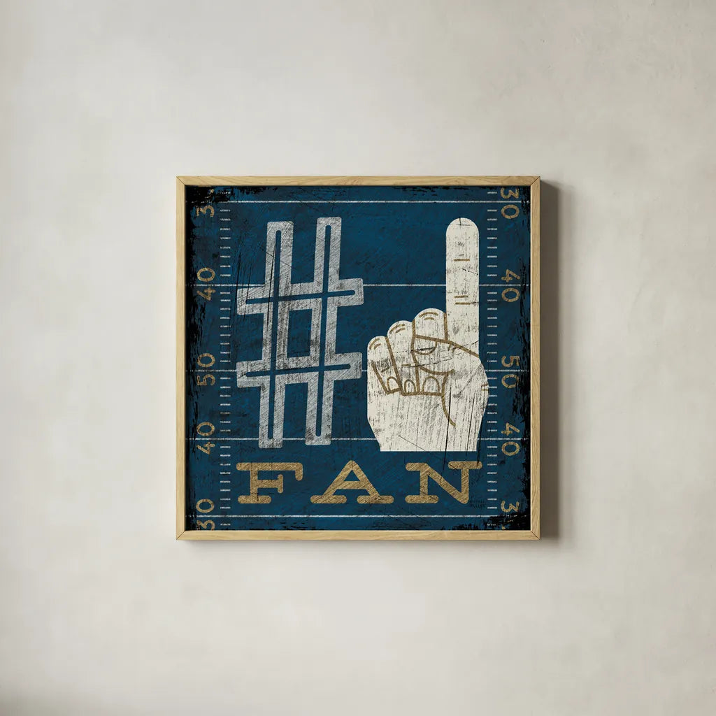 Football IV Blue by Michael Mullan. Shown in a natural wood glass frame for a timeless modern aesthetic. Available as an archival giclee rolled canvas, fine art paper, or poster print. SKU 20349a.