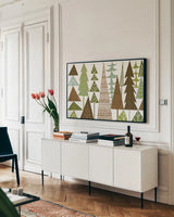 Forest Folklore Green Trees by Michael Mullan. shown as a framed stretched canvas in a living room above a console. Available as a archival giclee rolled canvas, fine art paper, or poster print. SKU 21524i.