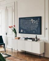 Hand Lettered US Map Blueprint by Michael Mullan. shown as a framed stretched canvas in a living room above a console. Available as a archival giclee rolled canvas, fine art paper, or poster print. SKU 16524i.
