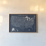 Hand Lettered US Map Blueprint by Michael Mullan. shown as a paper print in a natural frame. Available as a archival giclee rolled canvas, fine art paper, or poster print. SKU 16524i.