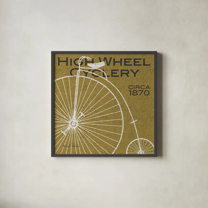 High Wheel Cyclery by Michael Mullan. Shown in a sleek black glass frame for a contemporary gallery look. Available as an archival giclee rolled canvas, fine art paper, or poster print. SKU 11869a.