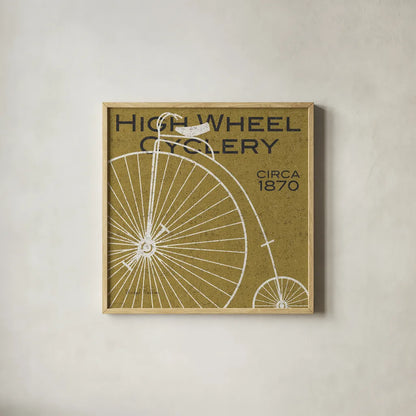 High Wheel Cyclery by Michael Mullan. Shown in a natural wood glass frame for a timeless modern aesthetic. Available as an archival giclee rolled canvas, fine art paper, or poster print. SKU 11869a.