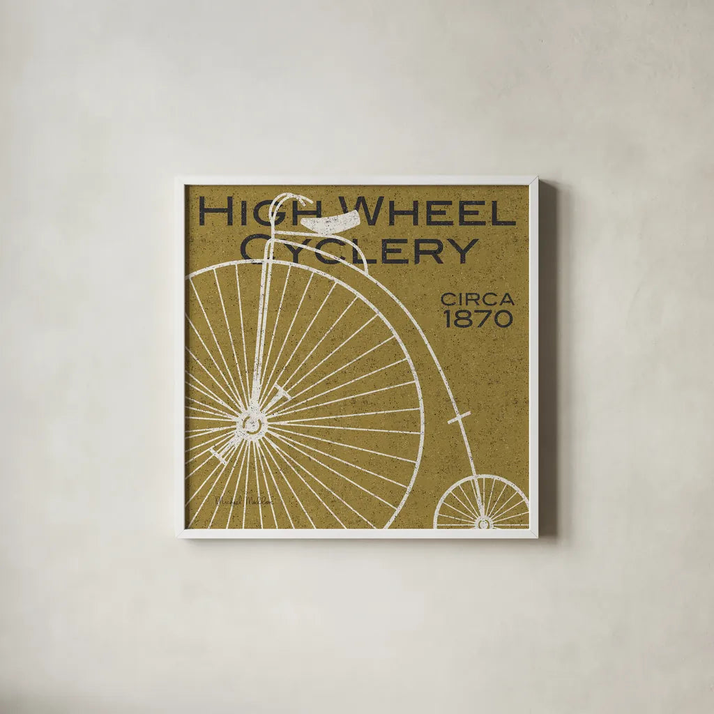 High Wheel Cyclery by Michael Mullan. Shown in a crisp white glass frame for a clean and minimalist style. Available as an archival giclee rolled canvas, fine art paper, or poster print. SKU 11869a.