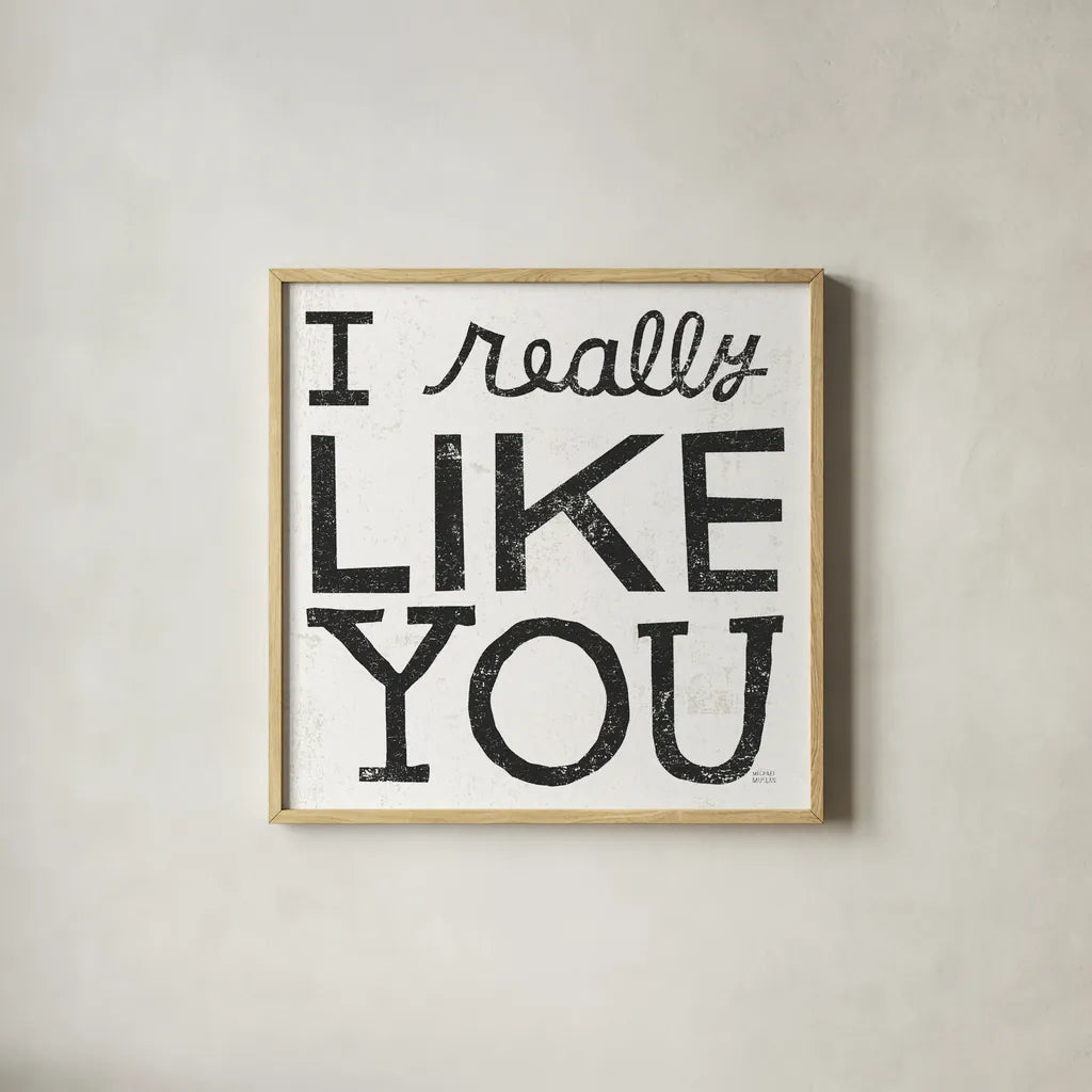 I Really Like You Black by Michael Mullan. Shown in a natural wood glass frame for a timeless modern aesthetic. Available as an archival giclee rolled canvas, fine art paper, or poster print. SKU 67866a.