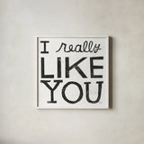 I Really Like You Black by Michael Mullan. Shown in a crisp white glass frame for a clean and minimalist style. Available as an archival giclee rolled canvas, fine art paper, or poster print. SKU 67866a.