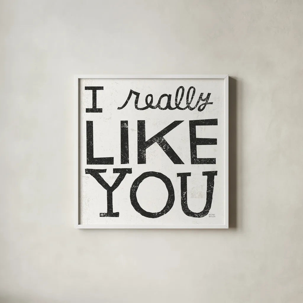 I Really Like You Black by Michael Mullan. Shown in a crisp white glass frame for a clean and minimalist style. Available as an archival giclee rolled canvas, fine art paper, or poster print. SKU 67866a.
