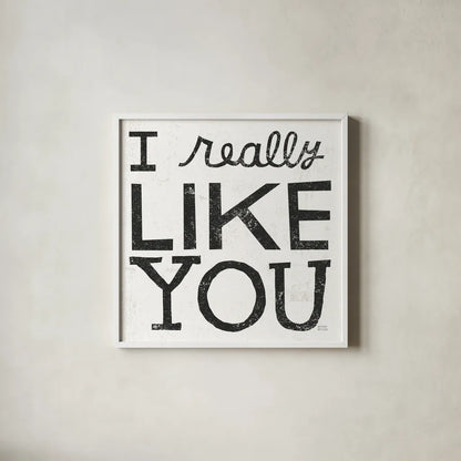 I Really Like You Black by Michael Mullan. Shown in a crisp white glass frame for a clean and minimalist style. Available as an archival giclee rolled canvas, fine art paper, or poster print. SKU 67866a.