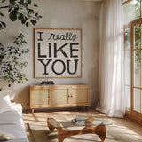 I Really Like You Black by Michael Mullan. Shown in a natural wood frame in a cozy modern living room. Available as an archival giclee rolled canvas, fine art paper, or poster print. SKU 67866a.