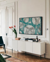 Industrial I Teal by Michael Mullan. shown as a framed stretched canvas in a living room above a console. Available as a archival giclee rolled canvas, fine art paper, or poster print. SKU 23174i.