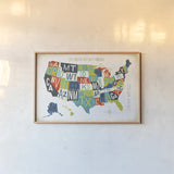 Letterpress USA Map by Michael Mullan. shown as a paper print in a natural frame. Available as a archival giclee rolled canvas, fine art paper, or poster print. SKU 29789i.