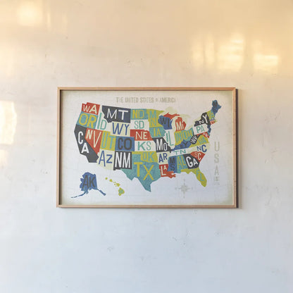 Letterpress USA Map by Michael Mullan. shown as a paper print in a natural frame. Available as a archival giclee rolled canvas, fine art paper, or poster print. SKU 29789i.