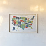 Letterpress USA Map by Michael Mullan. shown as a paper print in a white frame. Available as a archival giclee rolled canvas, fine art paper, or poster print. SKU 29789i.