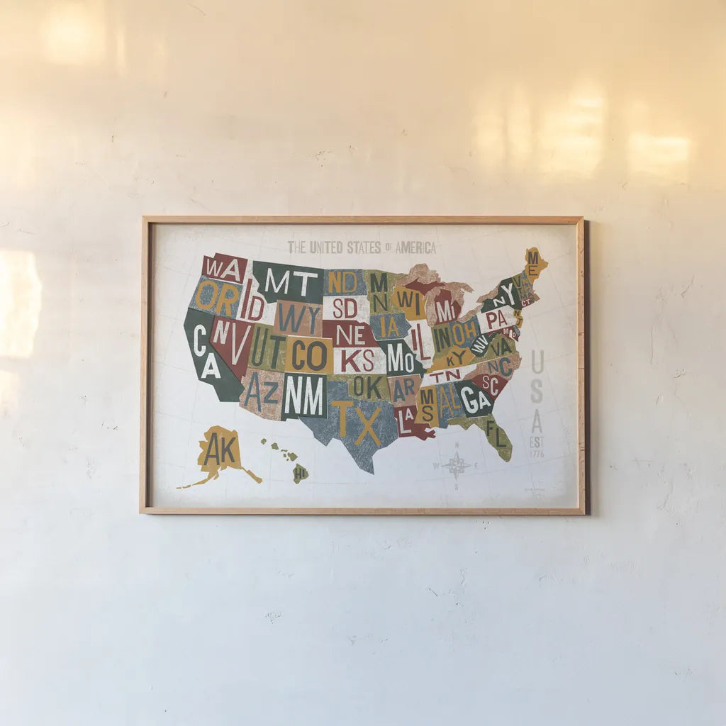 Letterpress USA Map Warm by Michael Mullan. shown as a paper print in a natural frame. Available as a archival giclee rolled canvas, fine art paper, or poster print. SKU 58963i.