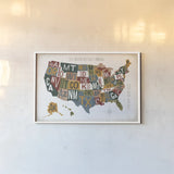 Letterpress USA Map Warm by Michael Mullan. shown as a paper print in a white frame. Available as a archival giclee rolled canvas, fine art paper, or poster print. SKU 58963i.