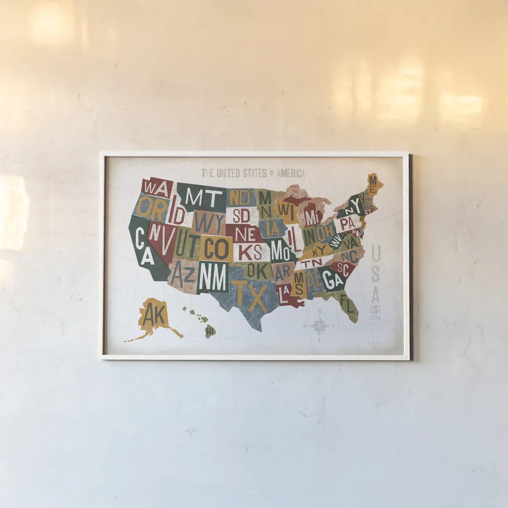 Letterpress USA Map Warm by Michael Mullan. shown as a paper print in a white frame. Available as a archival giclee rolled canvas, fine art paper, or poster print. SKU 58963i.