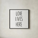 Love Lives Here Sq BW by Michael Mullan. Shown in a sleek black glass frame for a contemporary gallery look. Available as an archival giclee rolled canvas, fine art paper, or poster print. SKU 54656a.