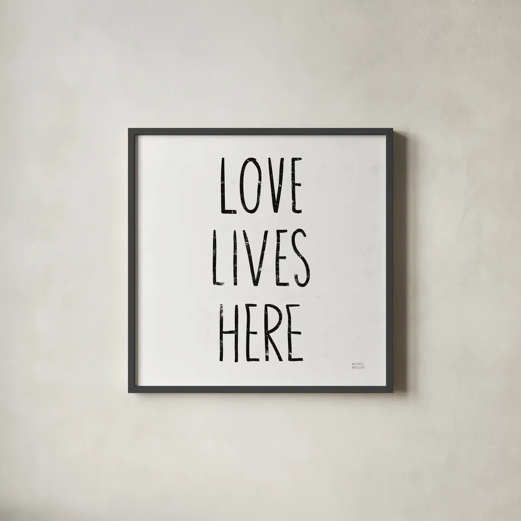 Love Lives Here Sq BW by Michael Mullan. Shown in a sleek black glass frame for a contemporary gallery look. Available as an archival giclee rolled canvas, fine art paper, or poster print. SKU 54656a.
