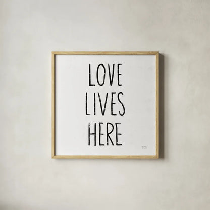 Love Lives Here Sq BW by Michael Mullan. Shown in a natural wood glass frame for a timeless modern aesthetic. Available as an archival giclee rolled canvas, fine art paper, or poster print. SKU 54656a.