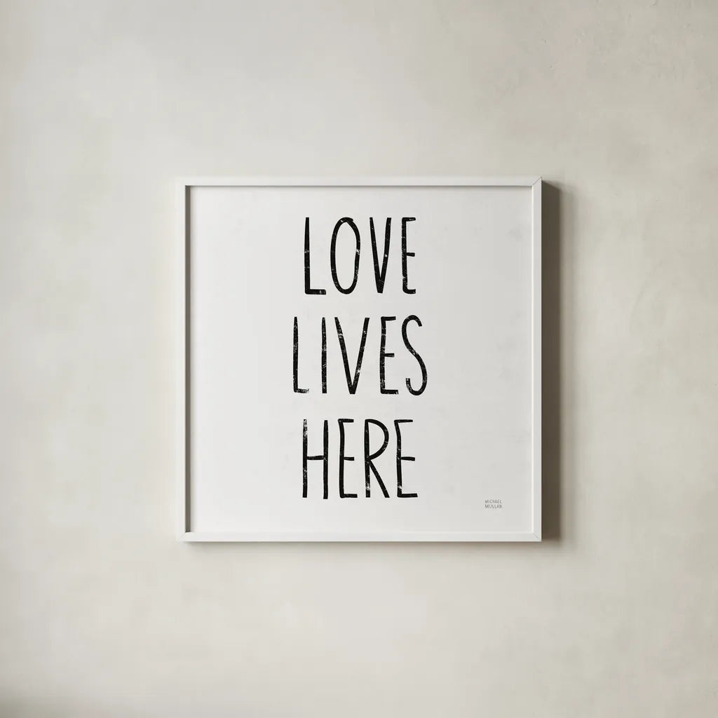 Love Lives Here Sq BW by Michael Mullan. Shown in a crisp white glass frame for a clean and minimalist style. Available as an archival giclee rolled canvas, fine art paper, or poster print. SKU 54656a.