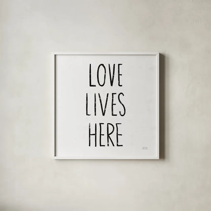Love Lives Here Sq BW by Michael Mullan. Shown in a crisp white glass frame for a clean and minimalist style. Available as an archival giclee rolled canvas, fine art paper, or poster print. SKU 54656a.