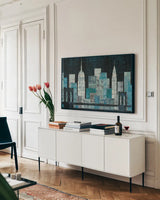 Majestic City Night by Michael Mullan. shown as a framed stretched canvas in a living room above a console. Available as a archival giclee rolled canvas, fine art paper, or poster print. SKU 50437i.
