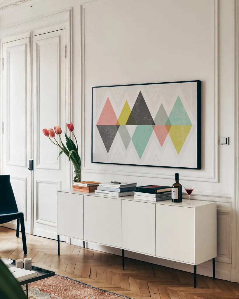 Mod Triangles II by Michael Mullan. shown as a framed stretched canvas in a living room above a console. Available as a archival giclee rolled canvas, fine art paper, or poster print. SKU 22318i.