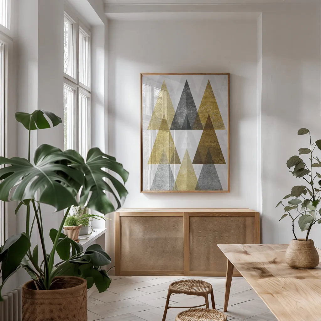 Mod Triangles IV Gold by Michael Mullan. shown as a print in a natural wood frame in a dining room. Available as a archival giclee rolled canvas, fine art paper, or poster print. SKU 22304h.