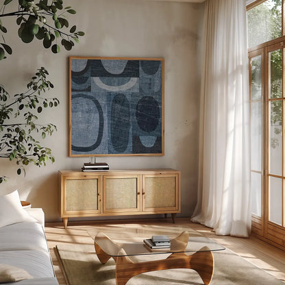 Modern Geometric Indigo and Navy I by Michael Mullan. Shown in a natural wood frame in a cozy modern living room. Available as an archival giclee rolled canvas, fine art paper, or poster print. SKU 18353a.