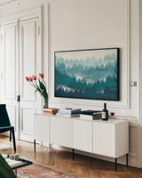Mountainscape Blue by Michael Mullan. shown as a framed stretched canvas in a living room above a console. Available as a archival giclee rolled canvas, fine art paper, or poster print. SKU 22466i.