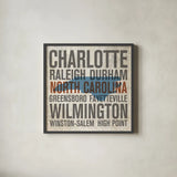 North Carolina by Michael Mullan. Shown in a sleek black glass frame for a contemporary gallery look. Available as an archival giclee rolled canvas, fine art paper, or poster print. SKU 18071a.