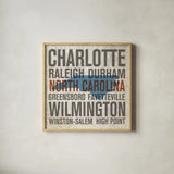 North Carolina by Michael Mullan. Shown in a natural wood glass frame for a timeless modern aesthetic. Available as an archival giclee rolled canvas, fine art paper, or poster print. SKU 18071a.
