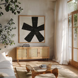 Punctuated Black Square VII by Michael Mullan. Shown in a natural wood frame in a cozy modern living room. Available as an archival giclee rolled canvas, fine art paper, or poster print. SKU 9115a.