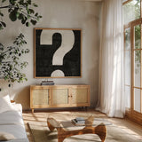 Punctuated Black Square VIII by Michael Mullan. Shown in a natural wood frame in a cozy modern living room. Available as an archival giclee rolled canvas, fine art paper, or poster print. SKU 9041a.