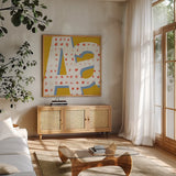 Punctuated Square IX Bright by Michael Mullan. Shown in a natural wood frame in a cozy modern living room. Available as an archival giclee rolled canvas, fine art paper, or poster print. SKU 56576a.