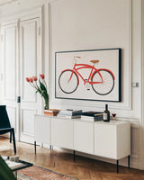 Red Beach Cruiser by Michael Mullan. shown as a framed stretched canvas in a living room above a console. Available as a archival giclee rolled canvas, fine art paper, or poster print. SKU 87840i.