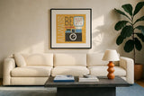 Retro Desktop Camera v2 by Michael Mullan. Displayed in a glass frame with matte in a clean modern living room. Available as an archival giclee rolled canvas, fine art paper, or poster print. SKU 60985a.