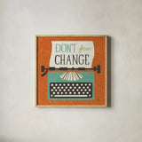 Retro Desktop Typewriter Don't Fear Change by Michael Mullan. Shown in a natural wood glass frame for a timeless modern aesthetic. Available as an archival giclee rolled canvas, fine art paper, or poster print. SKU 65001a.
