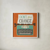 Retro Desktop Typewriter Don't Fear Change by Michael Mullan. Shown in a crisp white glass frame for a clean and minimalist style. Available as an archival giclee rolled canvas, fine art paper, or poster print. SKU 65001a.