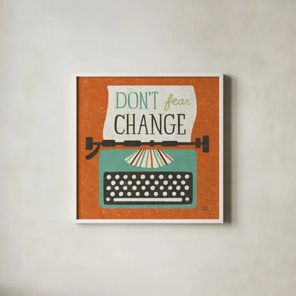 Retro Desktop Typewriter Don't Fear Change by Michael Mullan. Shown in a crisp white glass frame for a clean and minimalist style. Available as an archival giclee rolled canvas, fine art paper, or poster print. SKU 65001a.