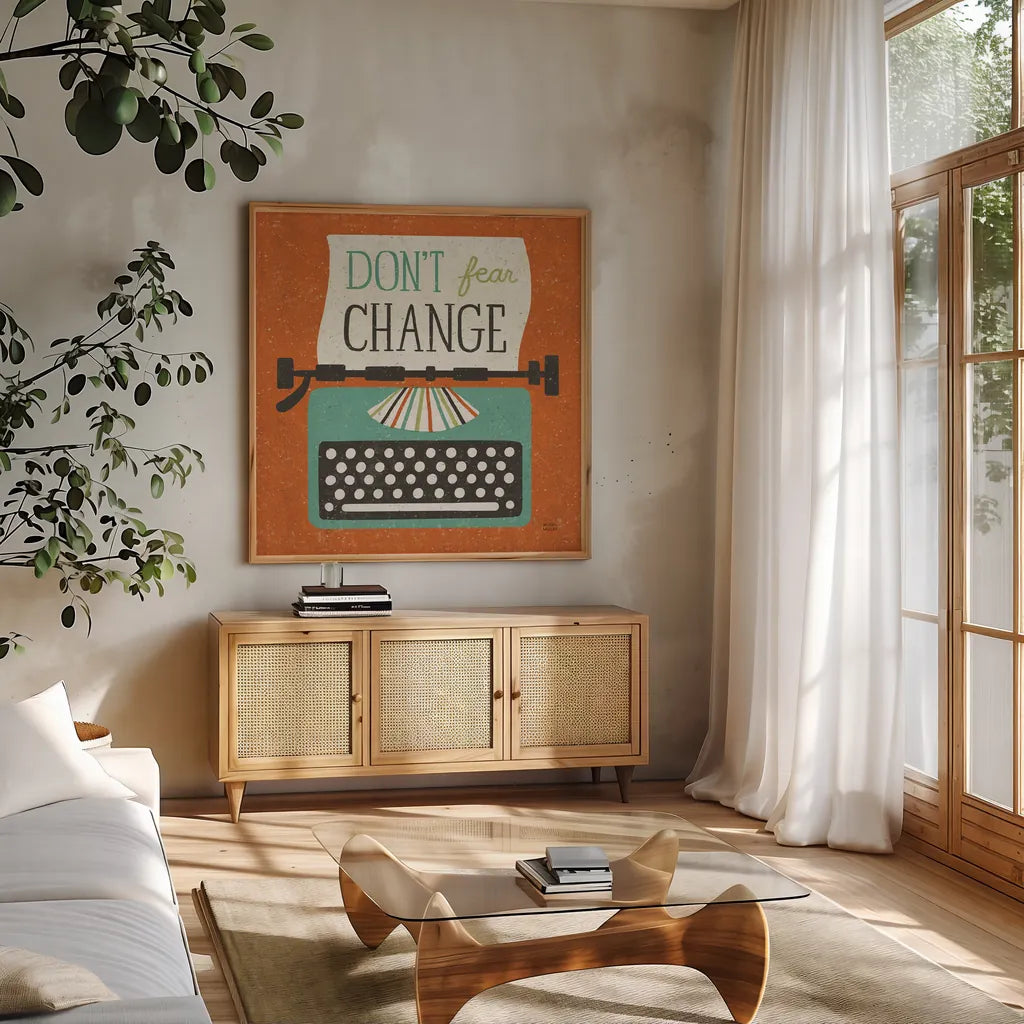 Retro Desktop Typewriter Don't Fear Change by Michael Mullan. Shown in a natural wood frame in a cozy modern living room. Available as an archival giclee rolled canvas, fine art paper, or poster print. SKU 65001a.