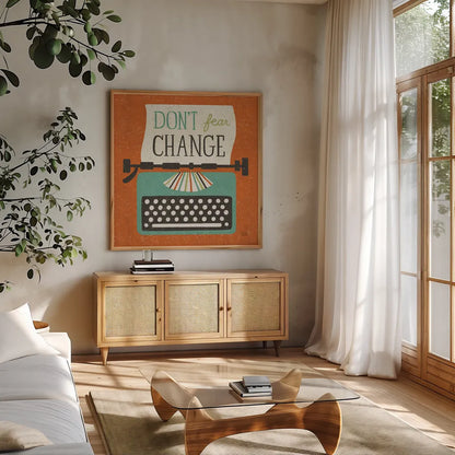 Retro Desktop Typewriter Don't Fear Change by Michael Mullan. Shown in a natural wood frame in a cozy modern living room. Available as an archival giclee rolled canvas, fine art paper, or poster print. SKU 65001a.