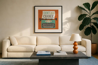 Retro Desktop Typewriter Don't Fear Change by Michael Mullan. Displayed in a glass frame with matte in a clean modern living room. Available as an archival giclee rolled canvas, fine art paper, or poster print. SKU 65001a.