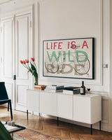 Road Trip Wild Ride by Michael Mullan. shown as a framed stretched canvas in a living room above a console. Available as a archival giclee rolled canvas, fine art paper, or poster print. SKU 19820i.