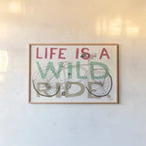 Road Trip Wild Ride by Michael Mullan. shown as a paper print in a natural frame. Available as a archival giclee rolled canvas, fine art paper, or poster print. SKU 19820i.