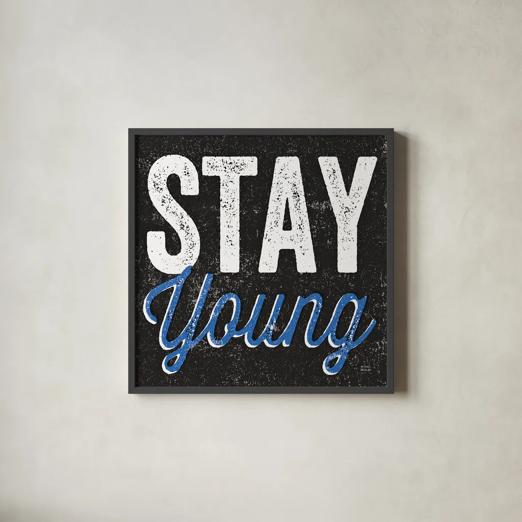 Stay Young by Michael Mullan. Shown in a sleek black glass frame for a contemporary gallery look. Available as an archival giclee rolled canvas, fine art paper, or poster print. SKU 13852a.