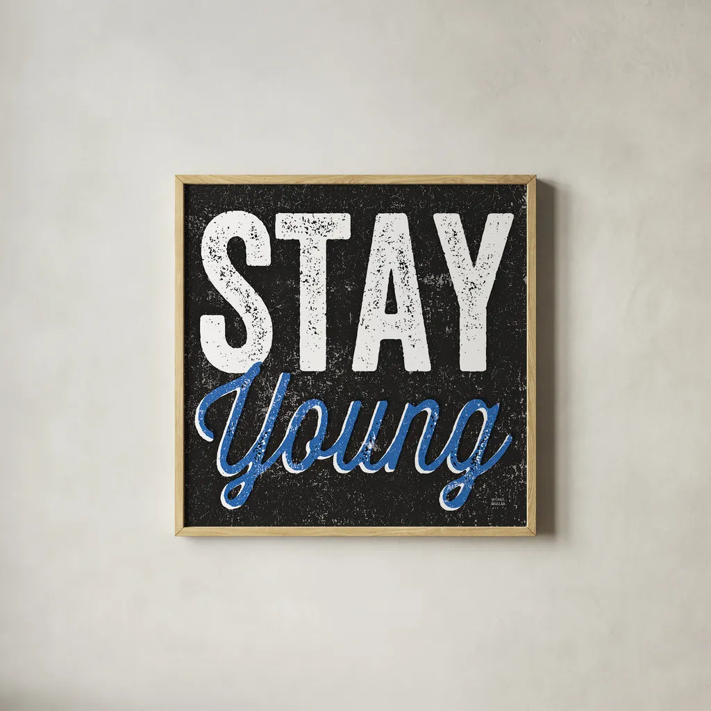 Stay Young by Michael Mullan. Shown in a natural wood glass frame for a timeless modern aesthetic. Available as an archival giclee rolled canvas, fine art paper, or poster print. SKU 13852a.
