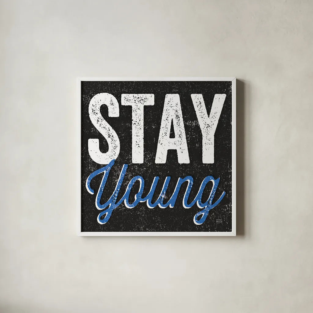 Stay Young by Michael Mullan. Shown in a crisp white glass frame for a clean and minimalist style. Available as an archival giclee rolled canvas, fine art paper, or poster print. SKU 13852a.